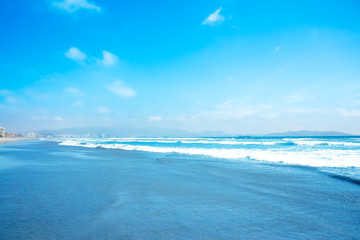 Fototapeta na wymiar Blue ocean waves and yellow sand
