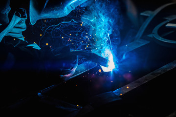 Welder during work , light , sparks , welding