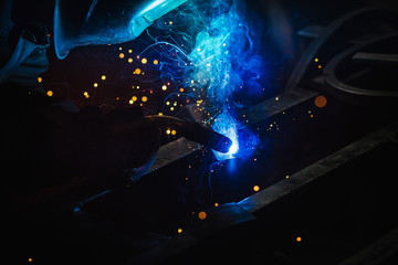 Welder during work , light , sparks , welding
