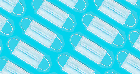 Medical face mask pattern isolated on blue background. Coronavirus COVID-19 protection concept. Top view