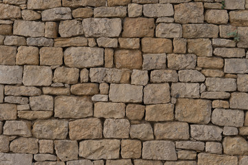 Close-up of old beige wall with stacked stones