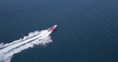 Aerial view of luxury motor boat racing on the water.