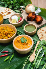 Various indian food menus, biryani rice, butter chicken, tandoori, bean curry and naan bread