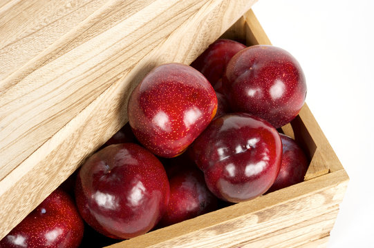 red apples in wooden box. White background. close view.  top view