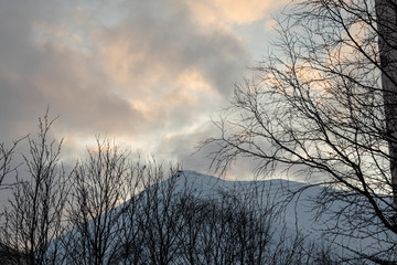 beautiful sunset clouds in the sky over the snow-covered mountain