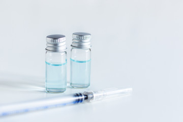 Medical glass vials and syringe for vaccination.