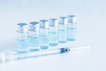 Medical glass vials and syringe for vaccination.