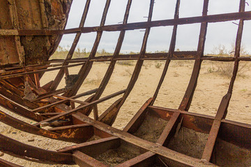 Rusty ship at the ship cemetery in former Aral sea  port town Moynaq (Mo‘ynoq or Muynak), Uzbekistan