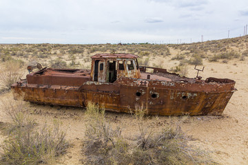 Rusty ship at the ship graveyard in former Aral sea  port town Moynaq (Mo‘ynoq or Muynak),...