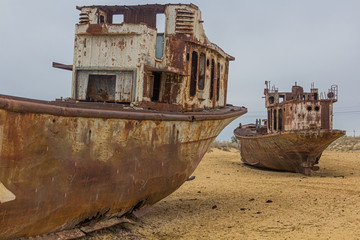 Rusty abandoned ships at the Ship cemetery at the former Aral sea coast in Moynaq (Mo‘ynoq or...
