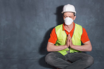 A man in a medical mask. Man in a pose for meditation. The concept of calm during the pandemic covid-19.