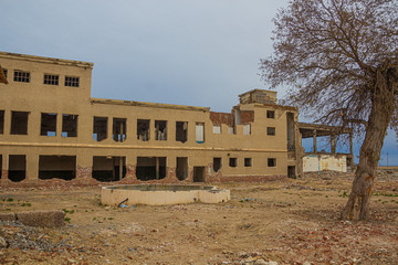 Ruins of abandoned fish canning factory in former Aral Sea port town Moynaq (Mo‘ynoq or Muynak),...