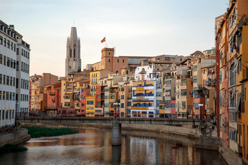 View of the bridge, colorful houses by the river and cathedral tower