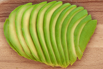 Fresh cut avocado sliced on a cutting board