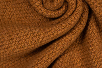 Fototapeta na wymiar Brown knitted fabric pattern.