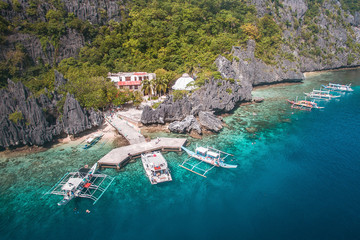 Aerial view of an abandoned site called Matinloc Shrine, the place was built in 1982 hidden between the beach and at the foot of towering karst cliffs.
