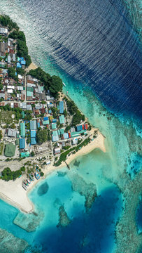 Aerial view of the local island Keyodhoo, Vaavu Atoll, Maldives, Indian Ocean with reef, shipyard. bikini  / guest beach and houses