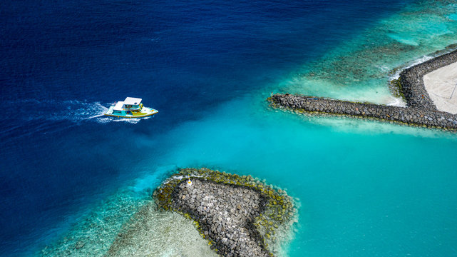 Aerial view of harbour  entry of Keyodhoo, Vaavu Atoll, Maldives, Indian Ocean with speedboat coming in