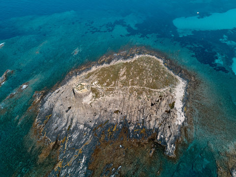 Aerial view of Isola della Pelosa isle and its historic bastion home of a seagulls colony, Stintino, Sardinia, Italy.
