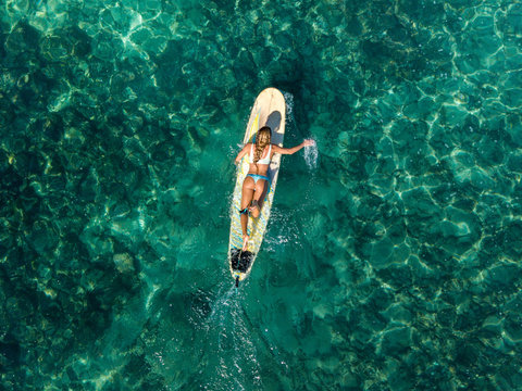 Aerial view of Trois Bassin Surf Spot, surfer paddling vertical view, Reunion Island, Indian Ocean