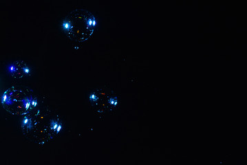 Soap bubbles isolated on a black background. Copy space.