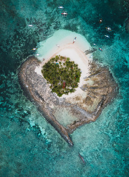 Aerial view of boats around Guyam Island, General Luna, Philippines