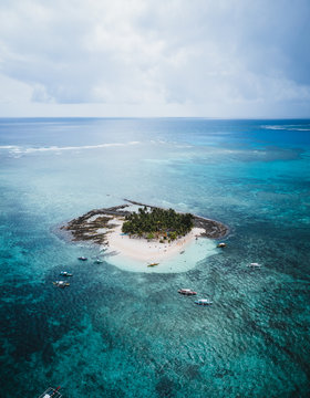 Aerial view of boats around Guyam Island, General Luna, Philippines