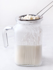Fermented kefir with granules of bacteria on a white background
