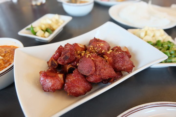 Close up fried fermented pork ribs, deep fried sour pork ribs on a white plate. Thai food.