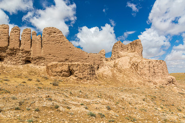 Eroded earthen walls of Ayaz Qala fortress in Kyzylkum desert, Uzbekistan