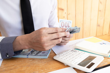 Businessman is counting money and plan to using reserve money for business.