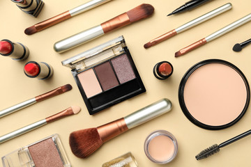 Different makeup cosmetics on beige background. Female accessories