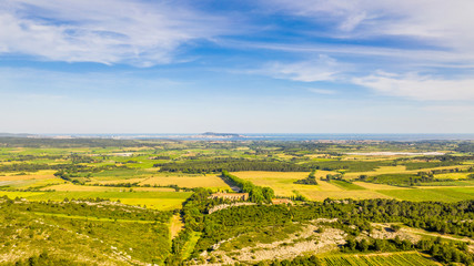 Panorama of the countryside behind Valemagne and the port of Sète in the distance in the Hérault in Occitania, France