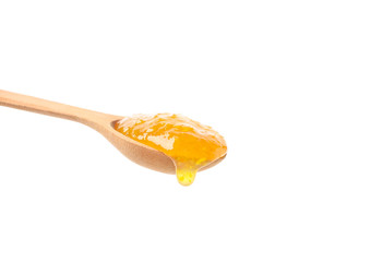 Spoon with apricot jam isolated on white background