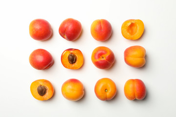 Flat lay with tasty apricots on white background, top view