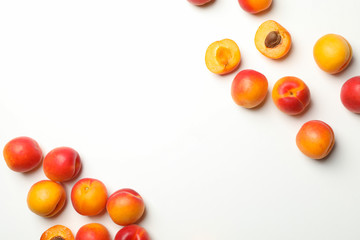 Fresh tasty apricots on white background, top view