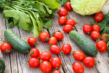 Vegetables and greens on a wood background
