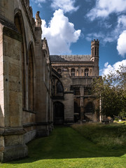 Fototapeta premium The parts of Peterborough Cathedral with beautiful sky and the garden