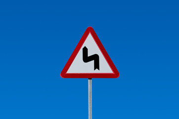 road bends left then right traffic sign