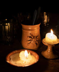 still life by candlelight with crystal glass a ceramic glass with a large chandelier and other ornaments