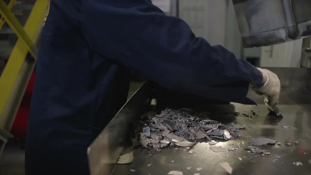 Factory Worker Collecting Metal Scrap, modern steel production industrial line, close up, 4k, RED Camera