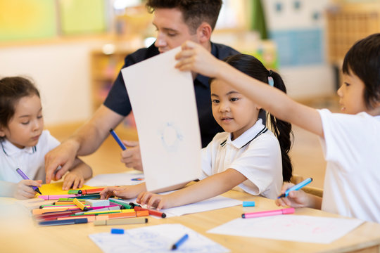 Foreign teacher teaching art class in classroom