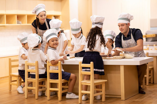 Children learning cooking in classroom