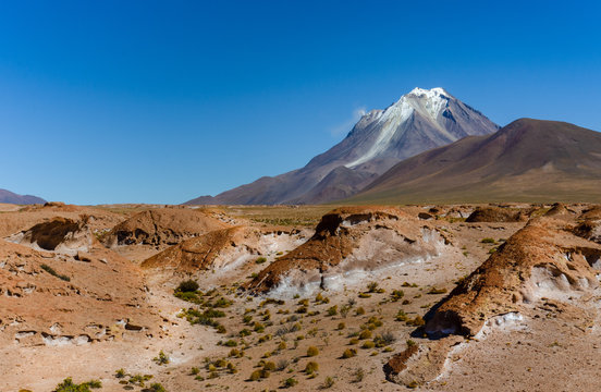 Crater of Tunupa Volcano near Uyuni, Bolivia. Amazing volcano landscape two days driving from Uyuni. With rock formations and steam coming from volcano. Selective focus.