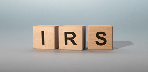 IRS word acronym inscription on wooden cubes on gray background