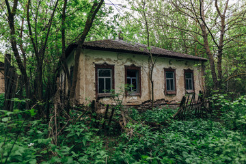 Old overgrown abandoned house in abandoned Russian village