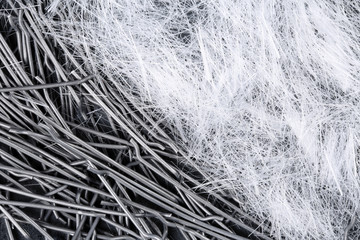 Extreme close up, top down view of polypropylene filament micro fibers and steel, end hooked fibers...