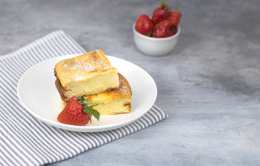 cottage cheese casserole with strawberries on a white plate