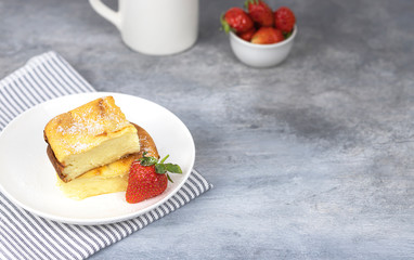 cottage cheese casserole with strawberries on a white plate