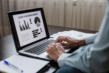 Businessman working remotely from home. Economic crisis derived from the covid19. Business financial risk background concept. Finance and economic background with statistic charts